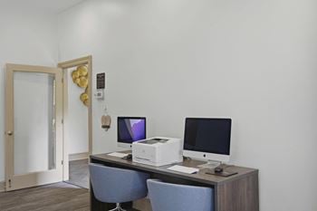 Business center with desktops and printer